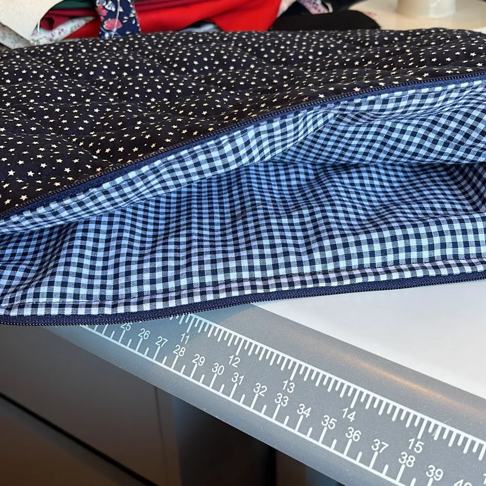 Navy polka dot fabric lined with blue gingham on the sewing table